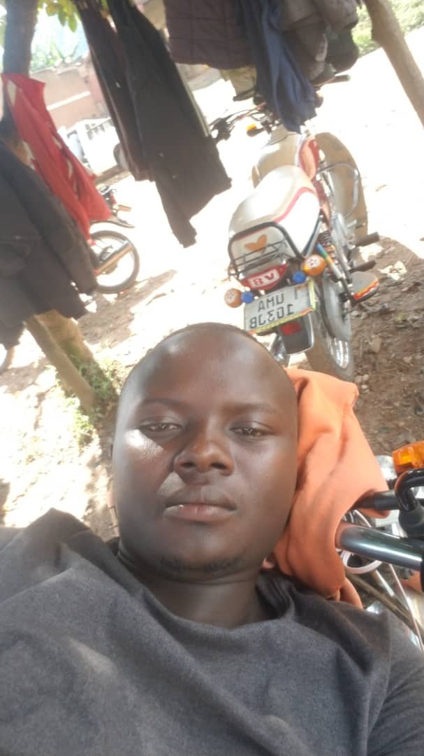 Norman with his motorcycle in Buhoma